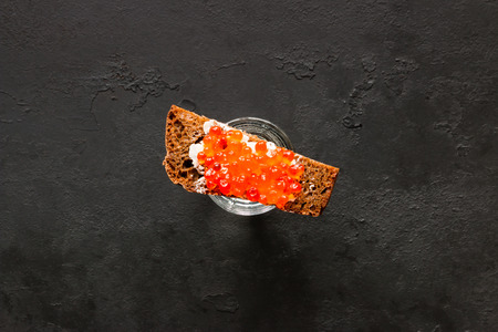 shot of vodka and rye bread with red caviar