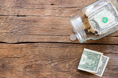 jar for donations with scattered moneyの写真素材