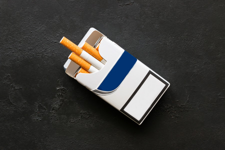A pack of cigarettes on a black background closeupの写真素材