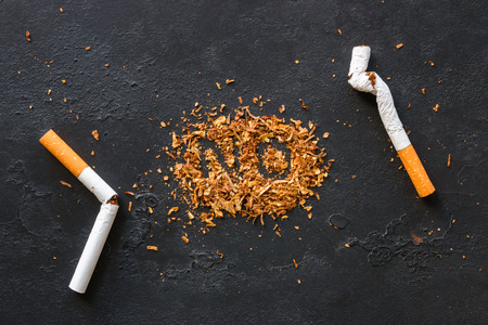broken cigarette and the the inscription "no" on tobacco - stop smoking conceptの写真素材