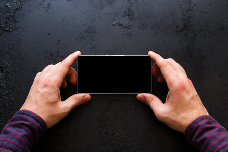 Man looks in smartphone with place for textの写真素材