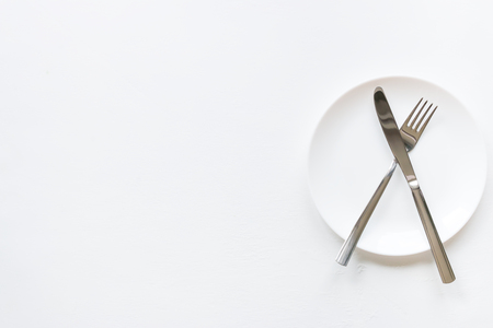 empty plate and cutlery with place for text on a white backgroundの写真素材