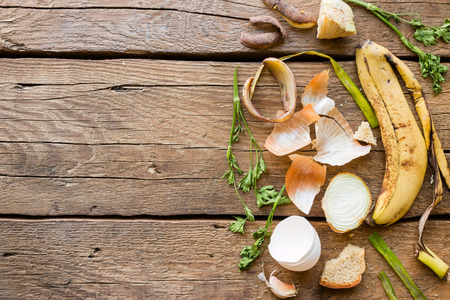 Food waste on a wooden background with space for textの写真素材