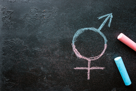 Symbol of a transgender drawn chalk on a black background with space for textの写真素材