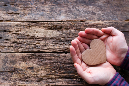 man holds a heart in his hands for Valentine's day with copy spaceの写真素材