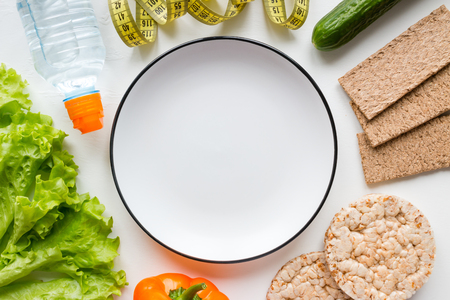 fresh vegetables, water, healthy food and empty plate with space for text concept dietの写真素材