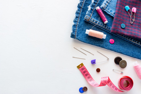 fabric and sewing accessories on a white background with place for textの写真素材