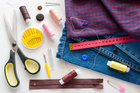 pieces of clothing and sewing accessories on a white backgroundの写真素材
