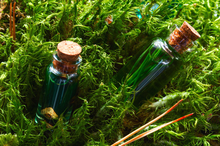 bottles of natural cosmetics in the moss close-up