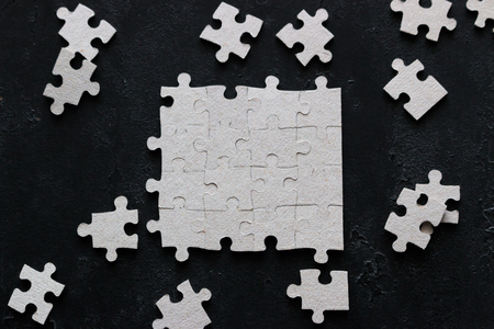 puzzle design and missing puzzle pieces on black backgroundの写真素材