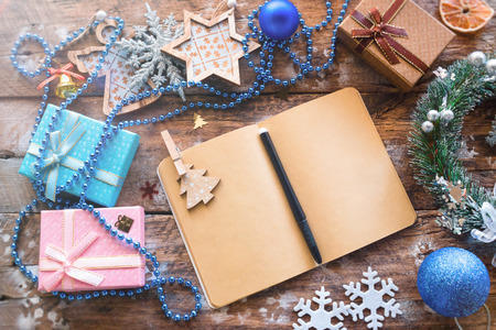 Christmas letter and Christmas decorations on a wooden background. Template
