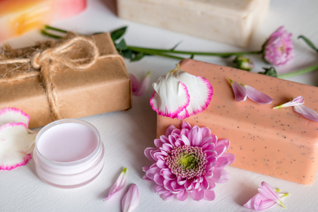 natural handmade cosmetics. soap and spa face cream from herbs and flowers on white backgroundの写真素材