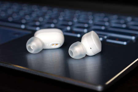 wireless  headphones on laptop background