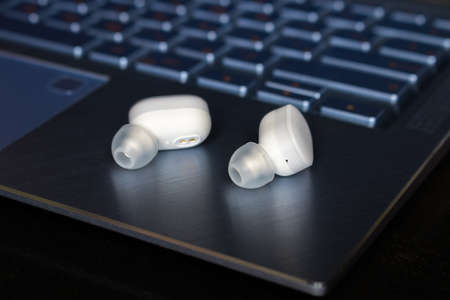 white wireless  headphones on laptop closeup
