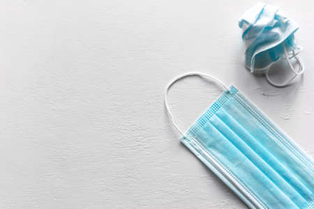 medical masks new and used on white background with place for text, second wave covid 19の写真素材