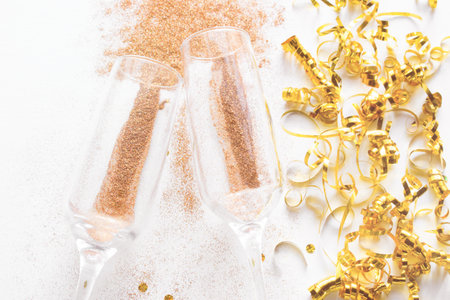 champagne glasses with sparkles close-up. holiday christmas concept on a white background