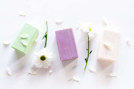 home made soap from natural ingredients and flowers on white backgroundの写真素材
