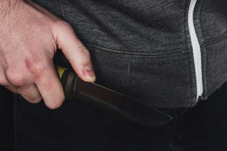 burglar criminal holding a knife close upの写真素材
