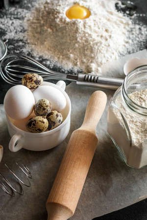 rolling pin, flour and eggs - ingredients and utensils for baking and cooking