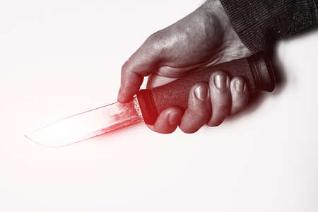holding knife in hand with red glow concept crimeの写真素材