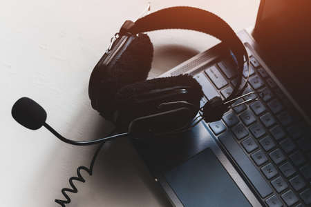 headphones on laptop keyboard concept remote work, distance educationの写真素材