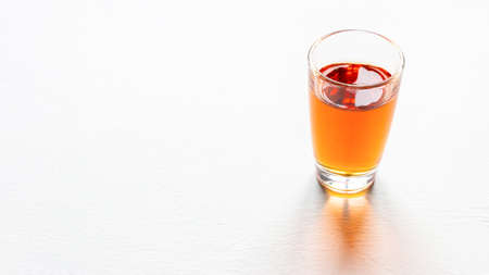 glass of alcohol on white background with place for textの写真素材