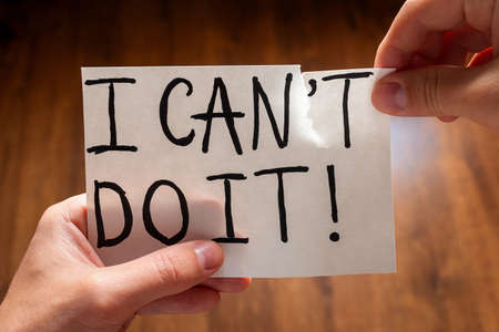 Man tears the word can't to read I can do it concept motivationの写真素材