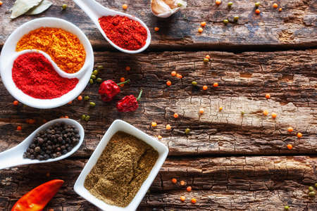 spices and herbs on wooden background with place for text
