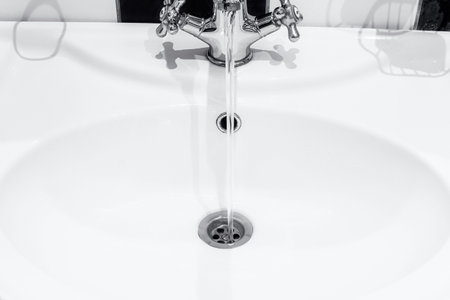 faucet and water in the bathroomの写真素材