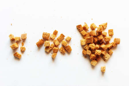 handfuls of white bread croutons on a light background close-upの写真素材
