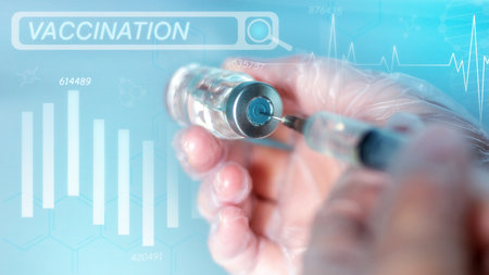 vaccination close-up vaccine and syringe in the doctor's hand on the background of the graphic...
