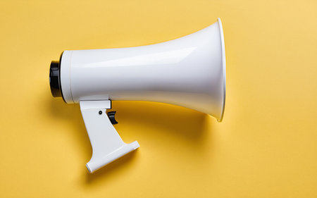 megaphone on a yellow background close-upの素材