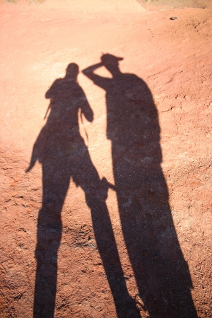 Shadow of man and woman on red earth