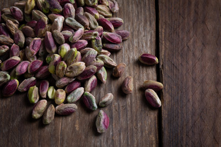 Pistachio Bronte Siciliano on Wood from Italy - Top View - Ingredient on Wooden Counter / Tableの写真素材