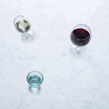 Wine from Italy, Isolated on Marble Background - Glasses of Italian Vino Rosso e Bianco, Red and White Wine, Shot Glass, Goblet Chalice Glass - Close-Up Macro, Top Viewの写真素材