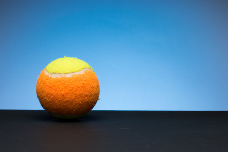 Tennis ball for children on gray and blue backgroundの写真素材