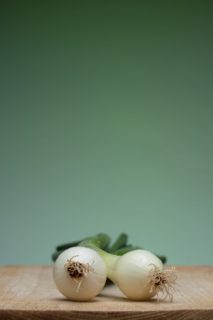 Fresh young onion on cutting boardの写真素材