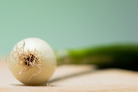 Fresh young onion on cutting boardの写真素材