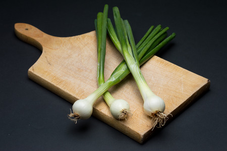 Fresh young onion on cutting board