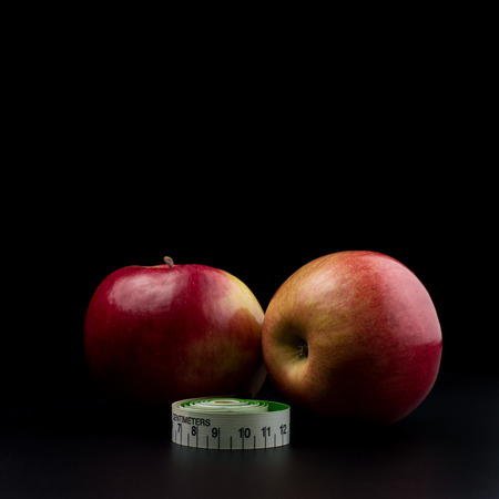 Home grown apples with meter ribbon on dark backgroundの写真素材