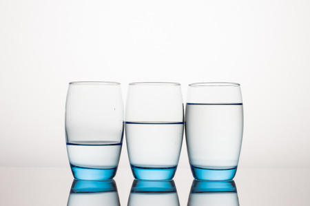 Three Water Glasses on Gray Background with clean reflection の写真素材