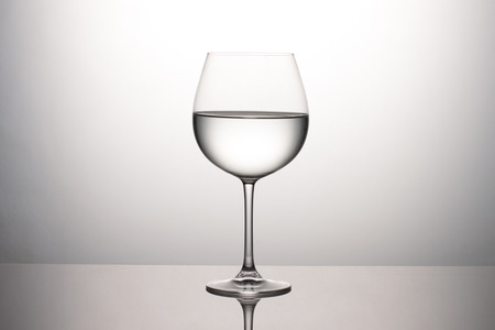 Water Glass on Gray Background with clean reflectionの写真素材