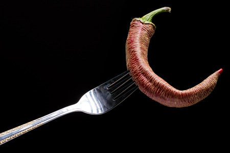 Red And Green Paprika Peppers On A Forkの写真素材