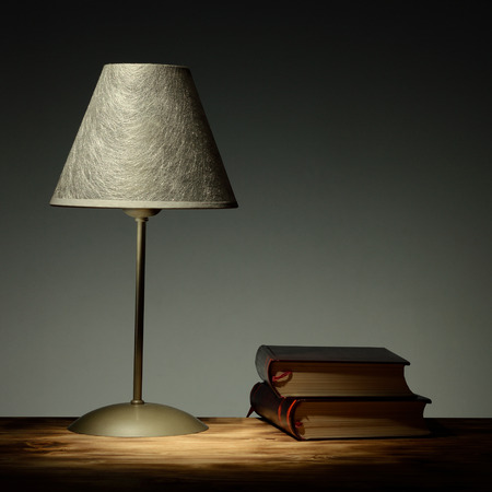 Minimalist lamp on retro background with books education conceptの写真素材