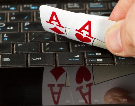 Two aces on a computer keyboard with a reflection 