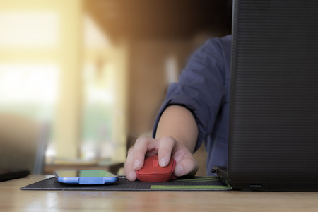 close up hand business man using mouse and laptop.の写真素材