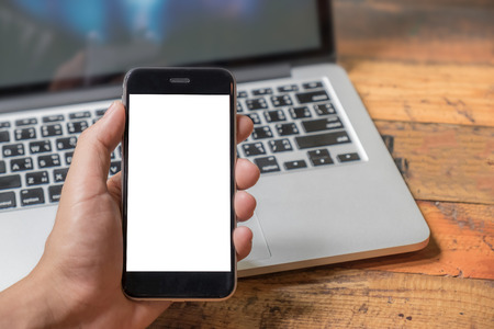 Close up of a man using smart phone with blank mobile and cup of coffee .Smart phone with blank screen and can be add your texts or others on smart phone.の写真素材