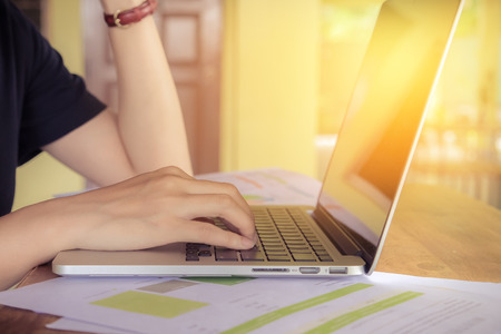 Young business sitting in home office with laptop. relax concept.side view.の写真素材