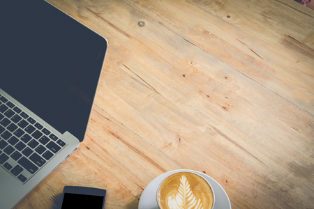 office stuff with notepad, laptop and coffee cup mouse notepad top view shot.vintage filter effect.の写真素材
