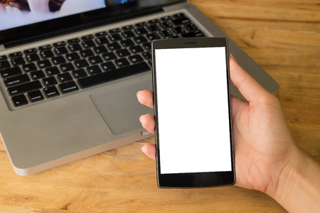 Close up of a women using smart phone with blank mobile and cup of coffee .Smart phone with blank screen and can be add your texts or others on smart phone.の写真素材